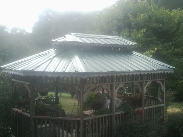 Two tier green metal roof on a garden gazebo in Delta City